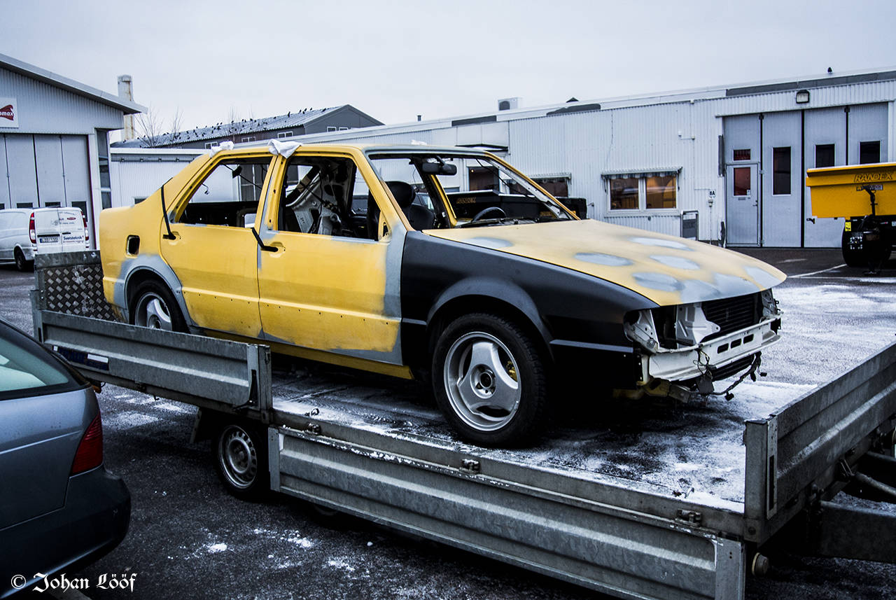 Yellow Saab 9000 on trailer